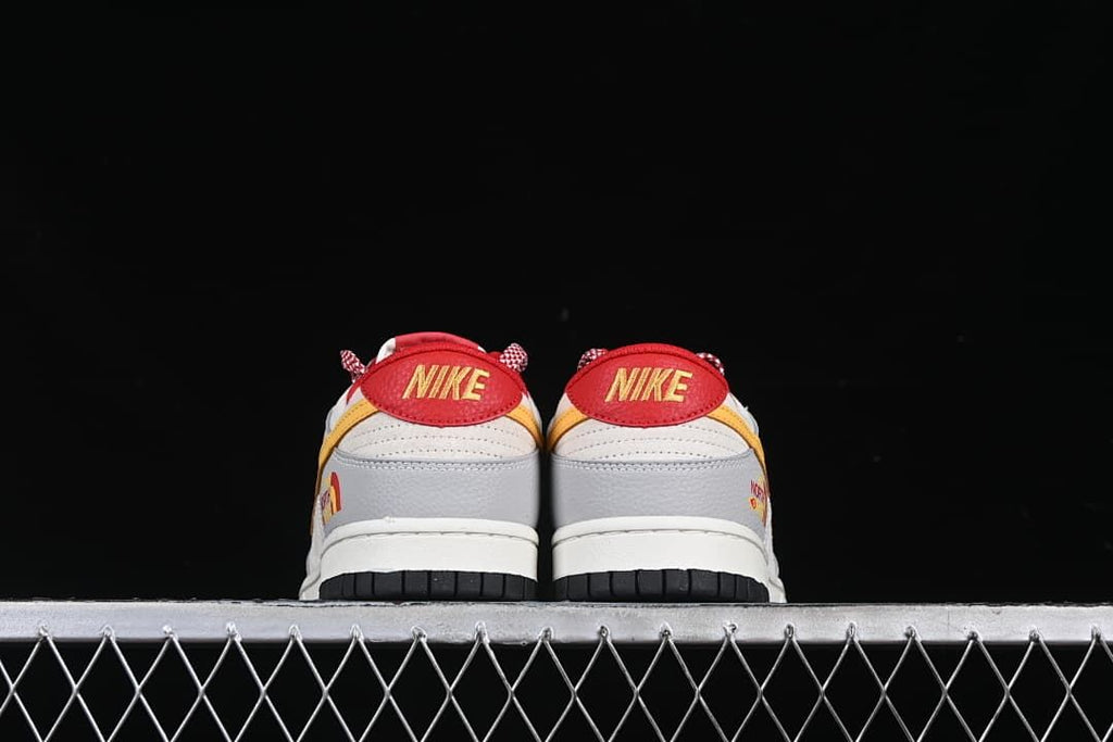 Rear view of both sneakers showing red heel tabs