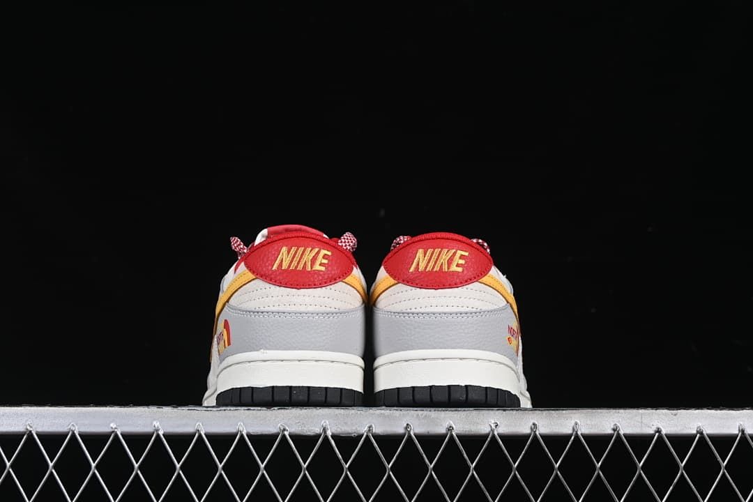 Rear view of both sneakers showing red heel tabs