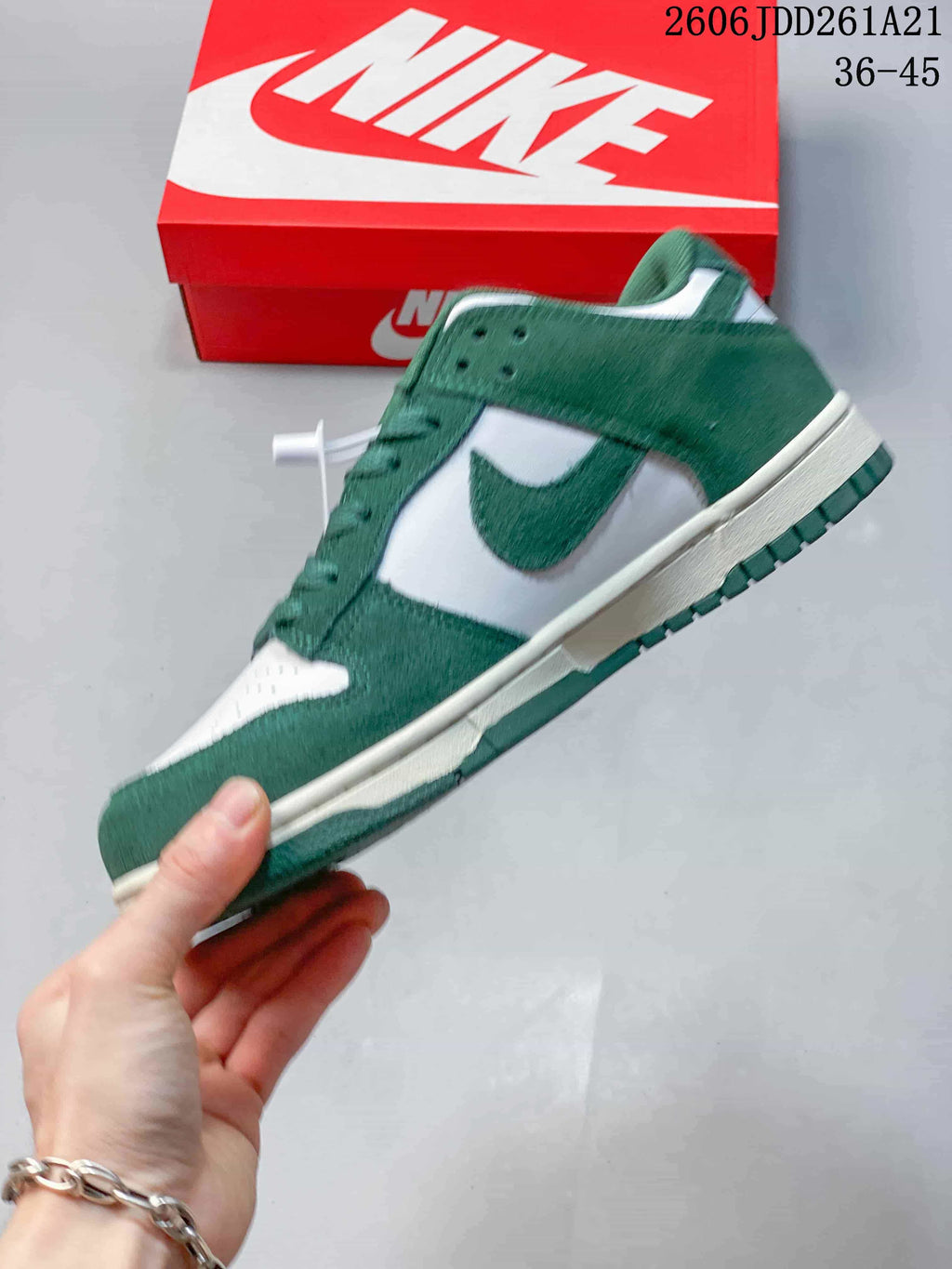 Side view of a green and white Nike Dunk Low sneaker