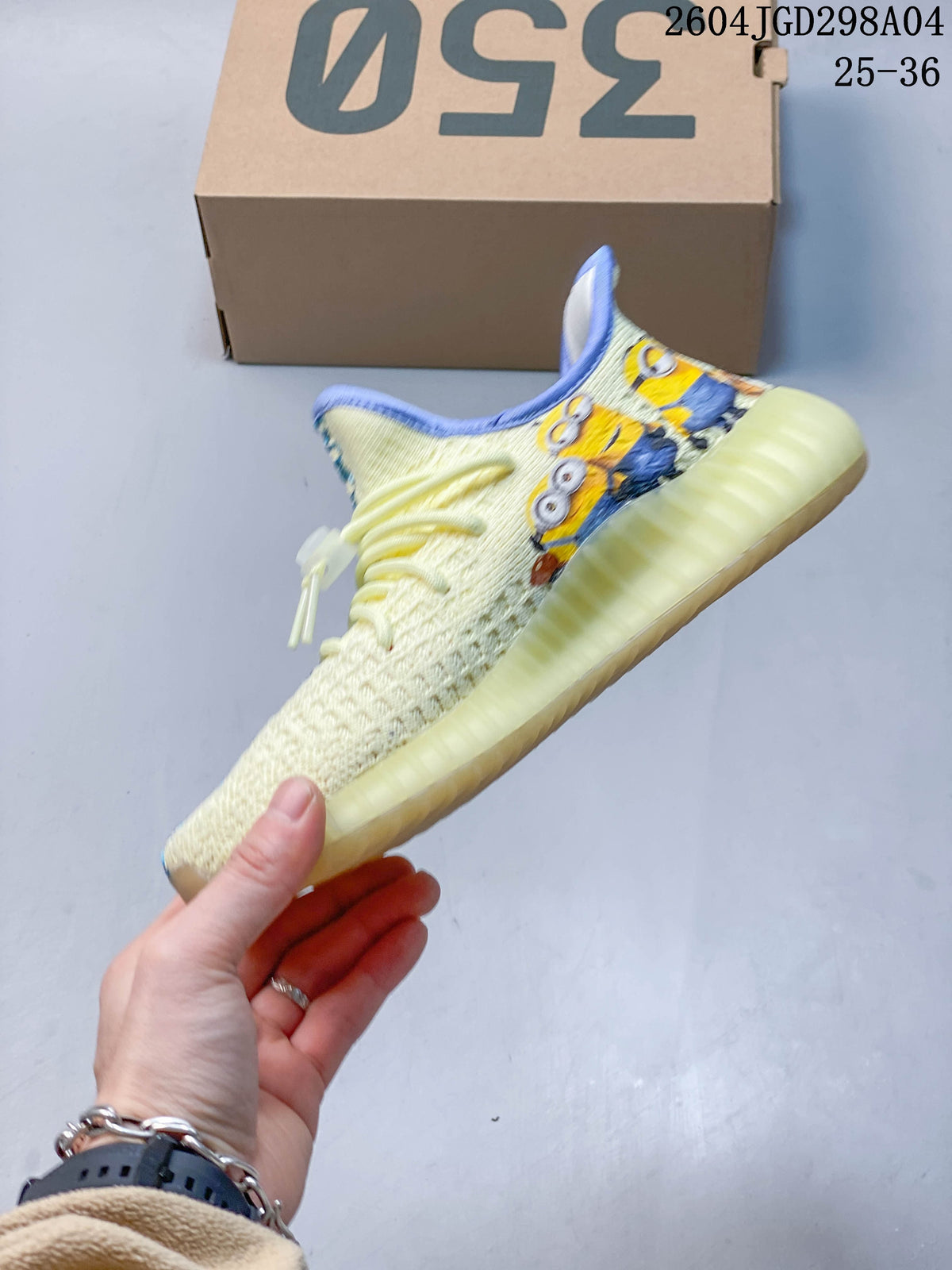 Side view showing the cream upper, colorful character graphics, and ribbed sole