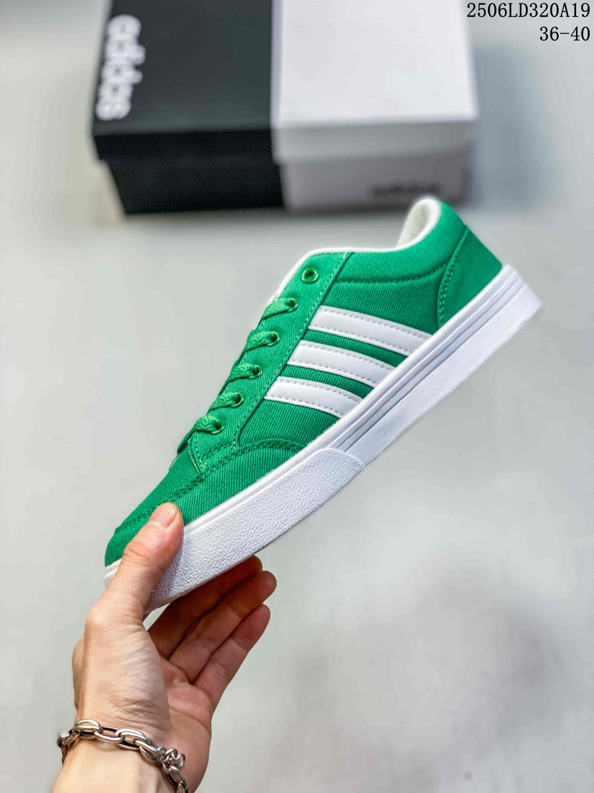 Side profile of a green low-top sneaker with three white stripes and a white sole