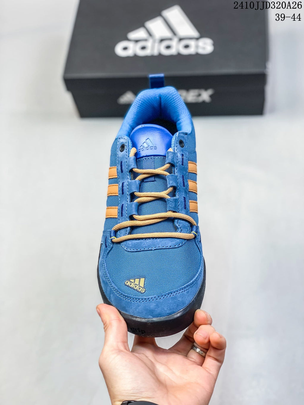 Front view of the blue adidas Daroga Plus shoe with tan laces and orange stripes.