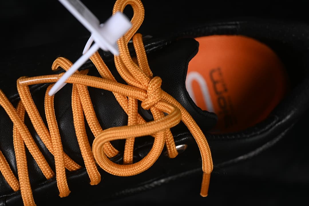 Close-up of orange laces and the inside of the shoe