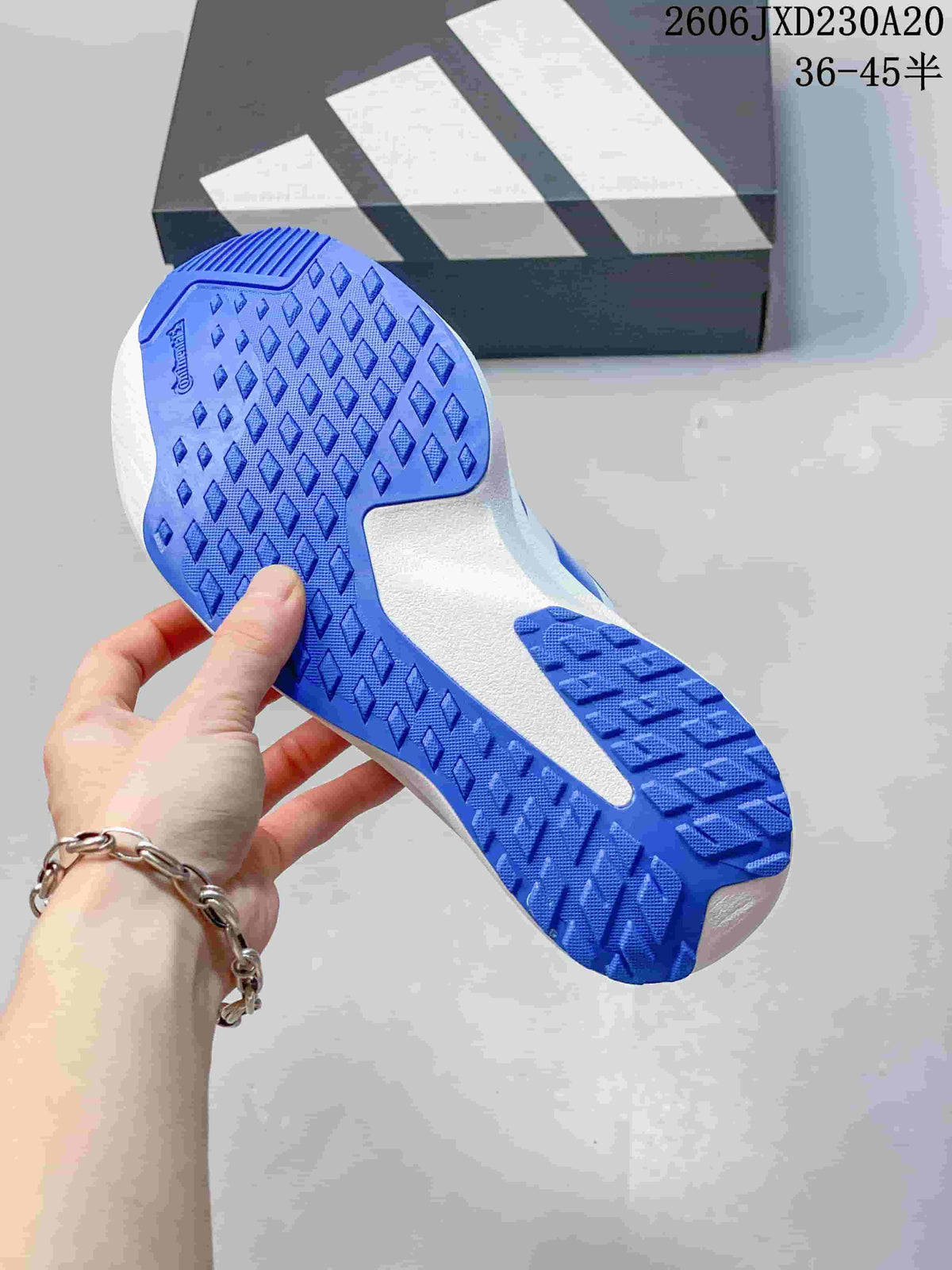 Close-up of the blue patterned outsole on an Adidas running shoe