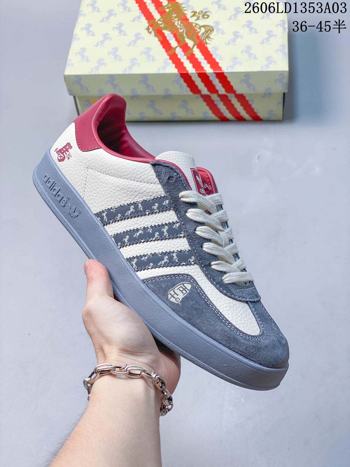 White Gazelle Indoor sneaker with blue-gray panels, patterned stripes, and horse motifs.