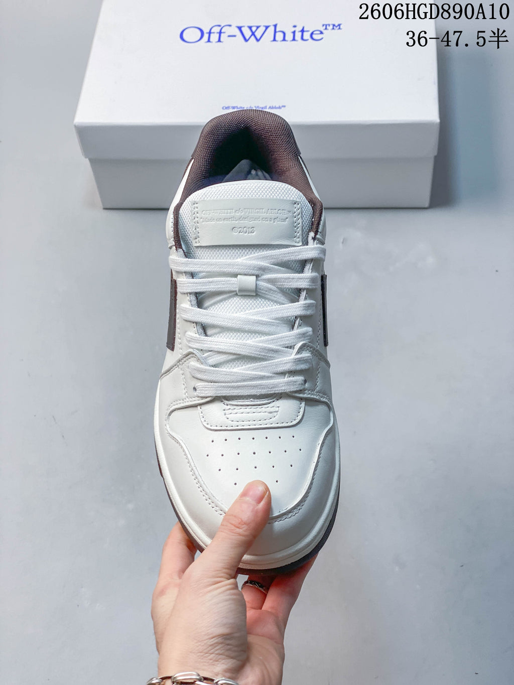 Top-down view showing the perforated toe, white laces, and padded brown collar.