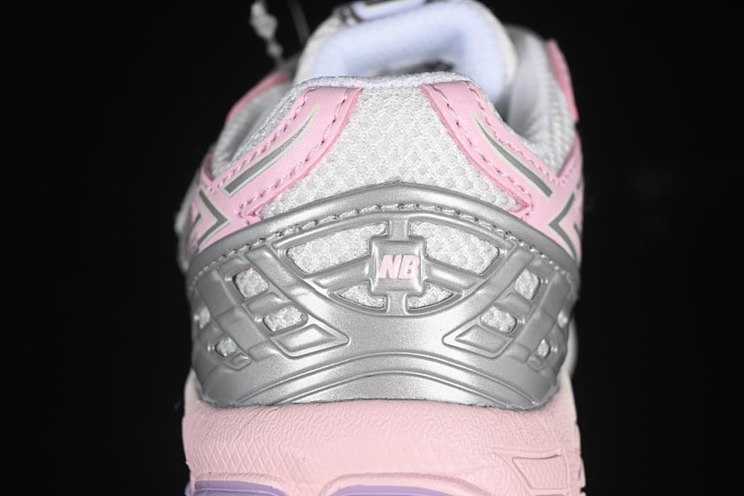 Rear view showing the silver heel detail and pink accents.