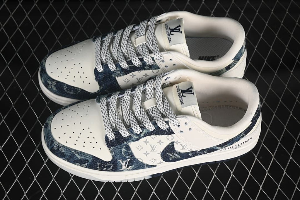 Pair of cream and dark blue denim-style low-top sneakers shown from above.
