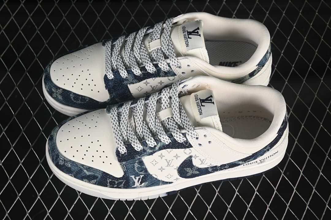Pair of cream and dark blue denim-style low-top sneakers shown from above.