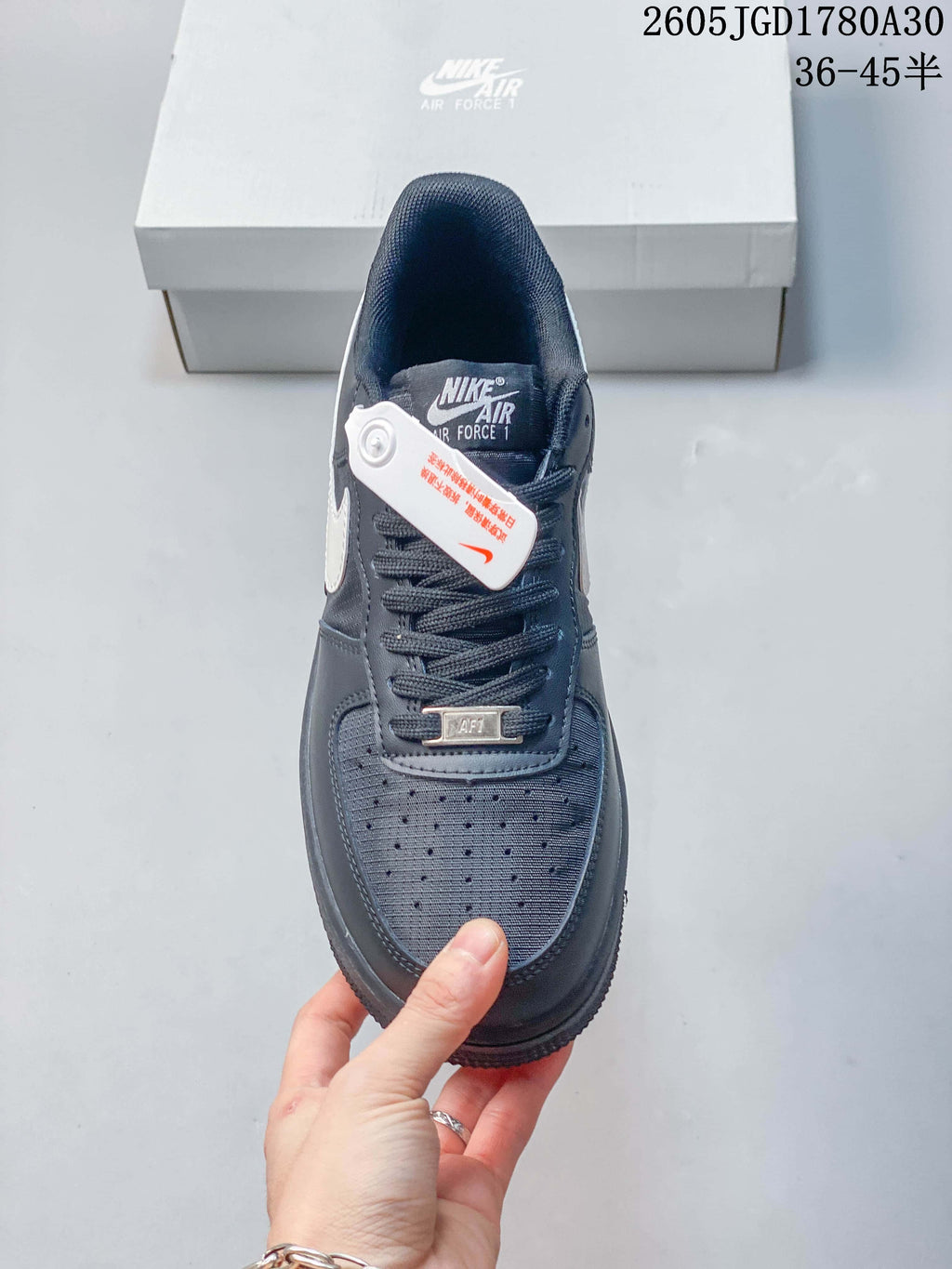 Top view of a dark gray Nike Air Force 1 Low sneaker showing its perforated toe and laces.