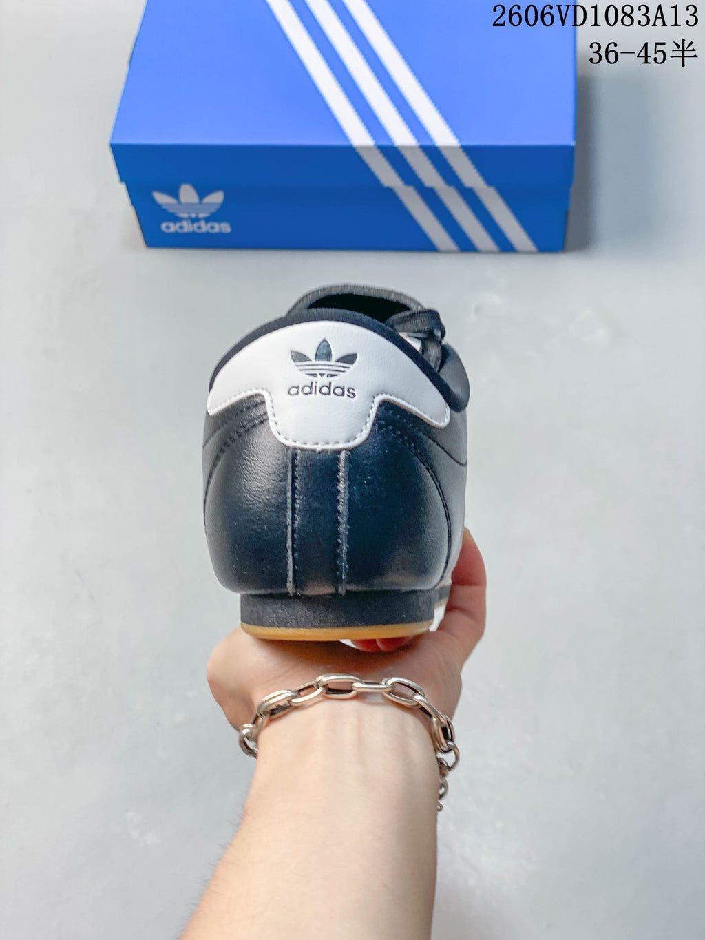 Rear view of the navy Adidas Originals Taekwondo sneaker with a white heel tab