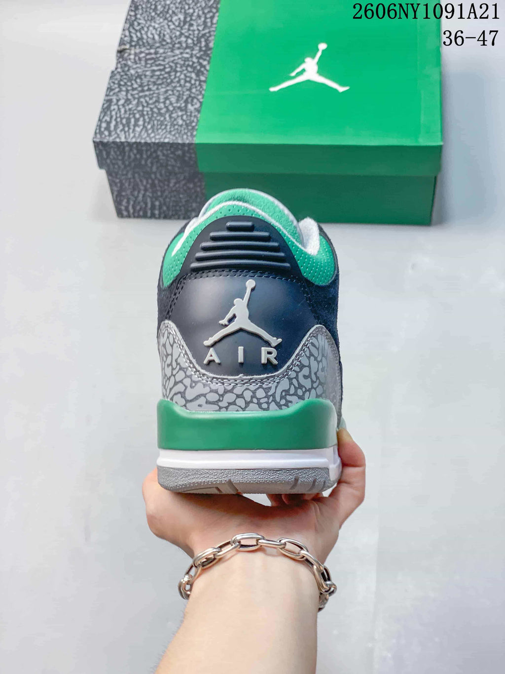 Rear view of the sneaker with patterned heel overlay and green accents