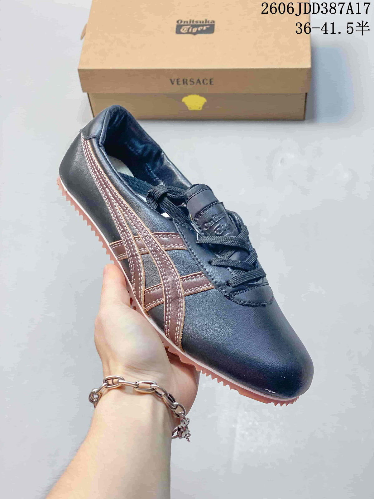 Side view of navy low-top sneakers with brown side stripes and a ridged outsole.