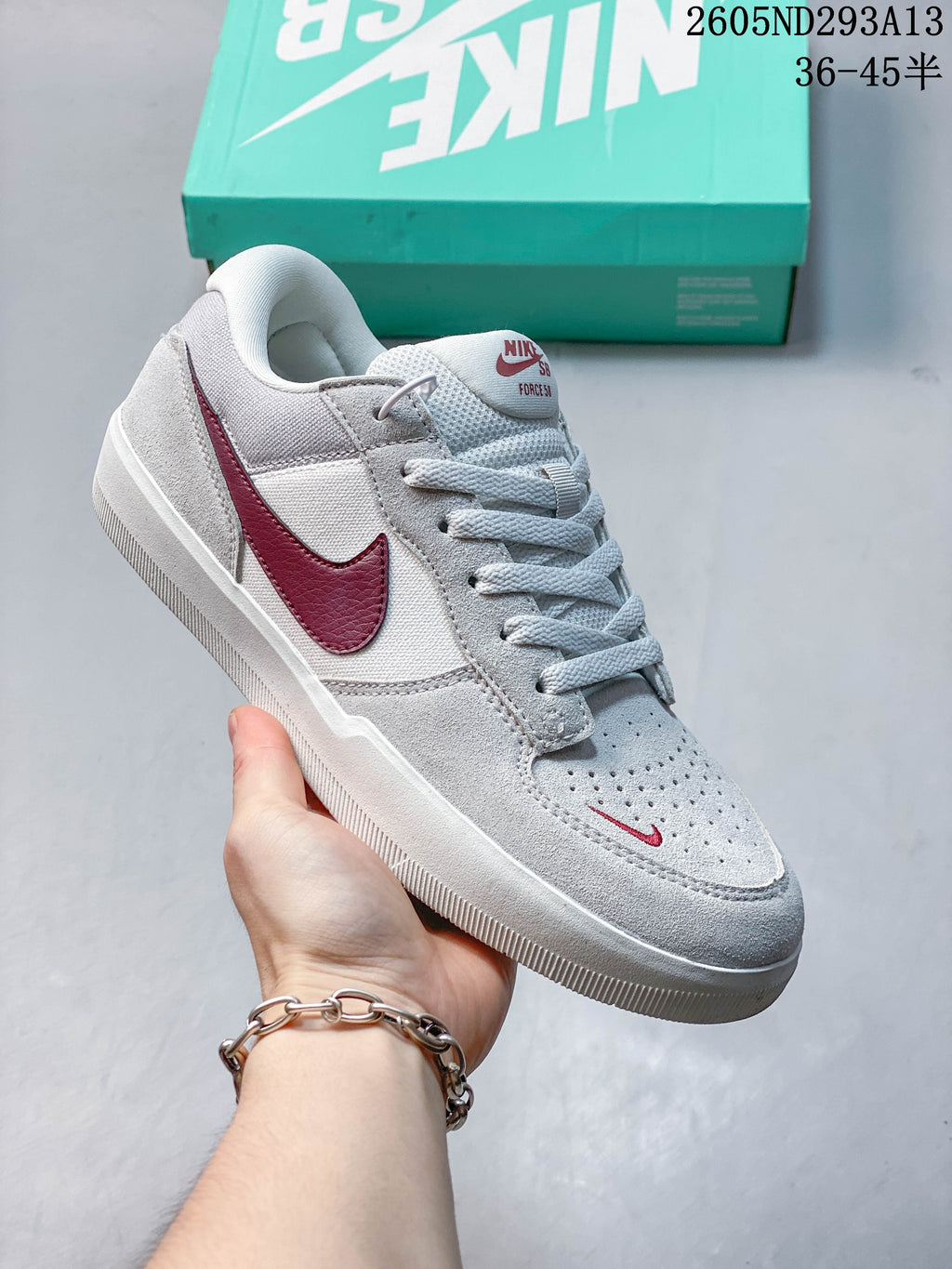 Light gray Nike SB Force 58 shoe with a burgundy Swoosh and matching small toe detail