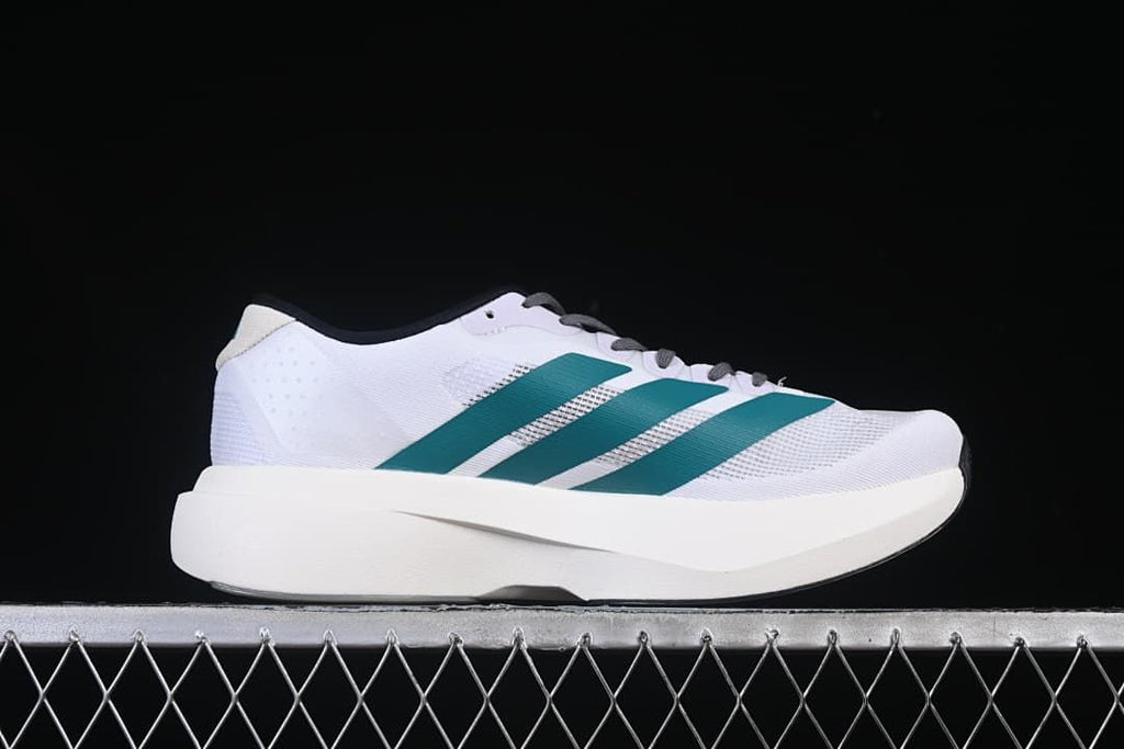 Side profile of the white running shoe with teal stripes.