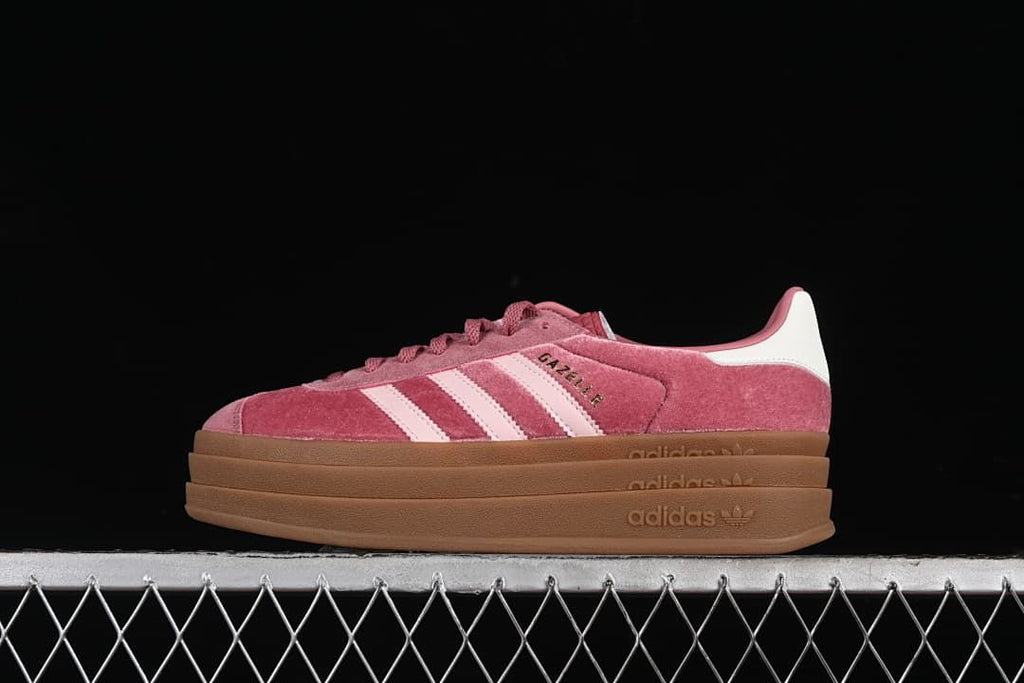 Side view of pink adidas Gazelle Bold sneakers with pale pink stripes and a layered gum platform sole