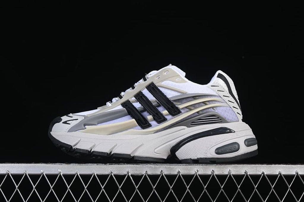Side view of the white, grey, cream and black sneaker