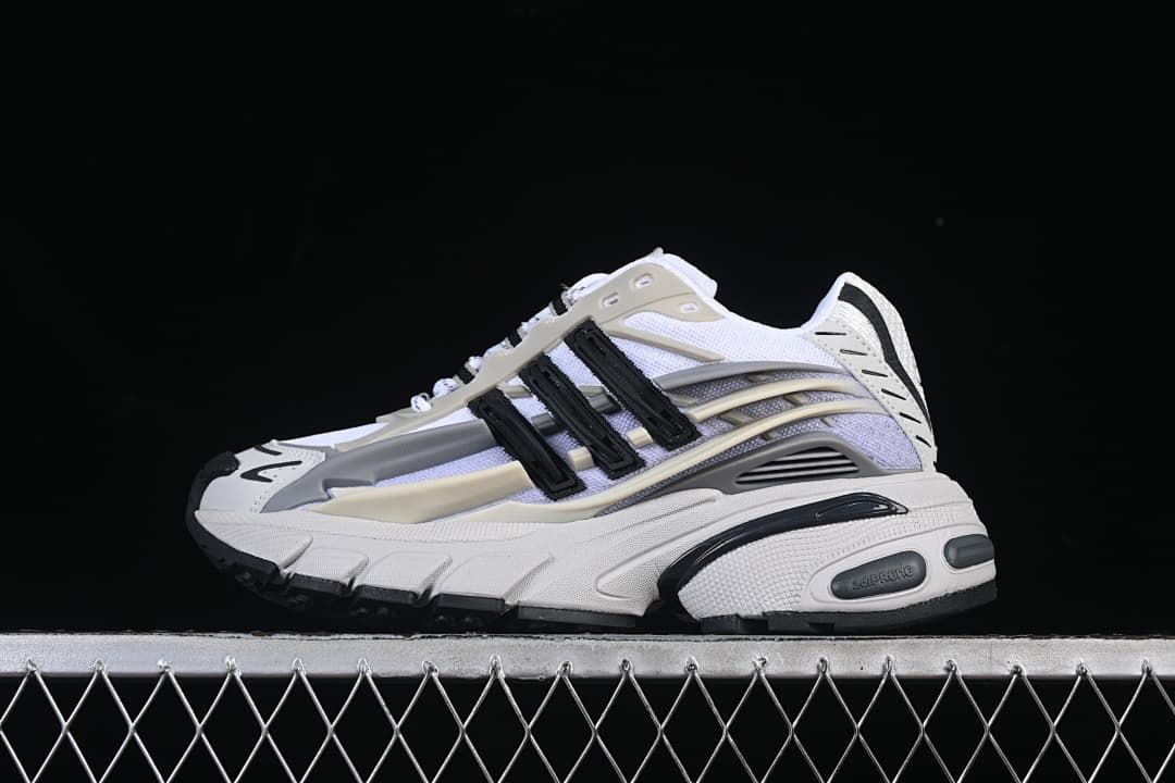 Side view of the white, grey, cream and black sneaker