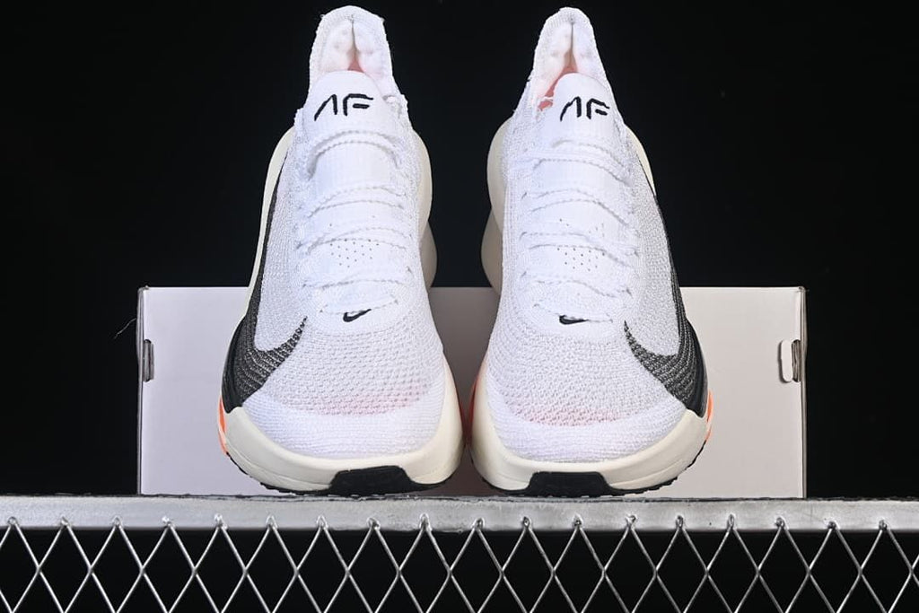 Front view of the pair of white running sneakers