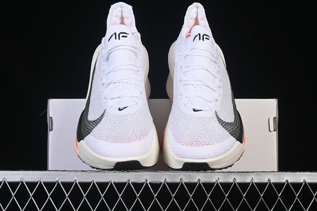 Front view of the pair of white running sneakers