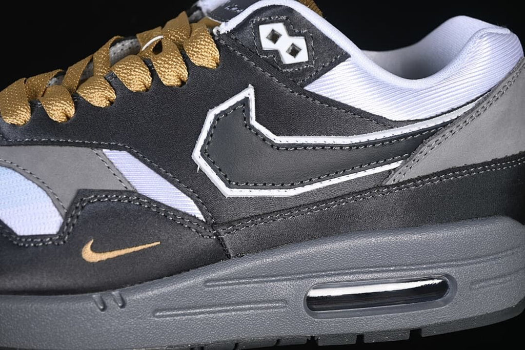 Close-up of the side panel, Swoosh, gold-tone accent, laces, and visible Air unit
