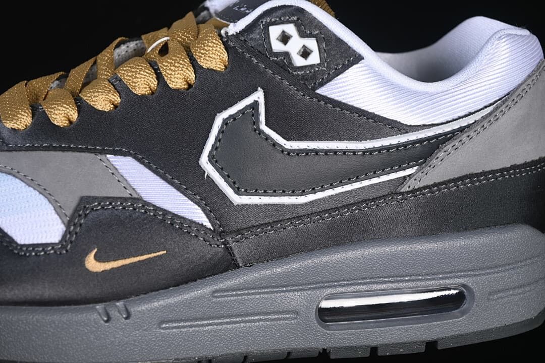 Close-up of the side panel, Swoosh, gold-tone accent, laces, and visible Air unit