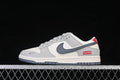 Side view of a grey and off-white Nike SB Dunk Low sneaker with a dark grey Swoosh and red Supreme branding.