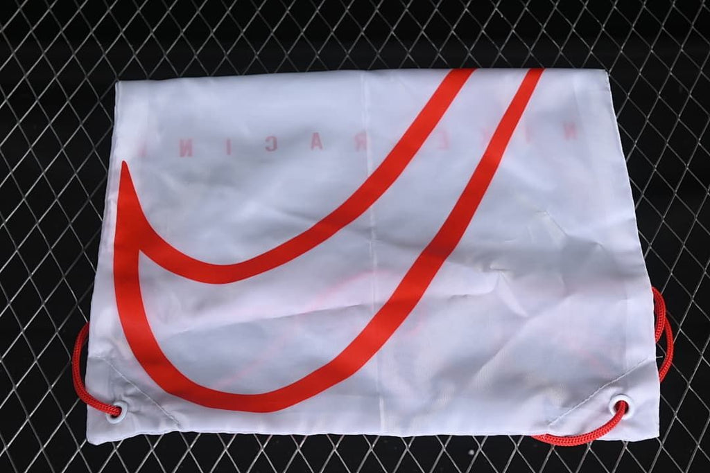 White drawstring bag with a large red Nike Swoosh logo
