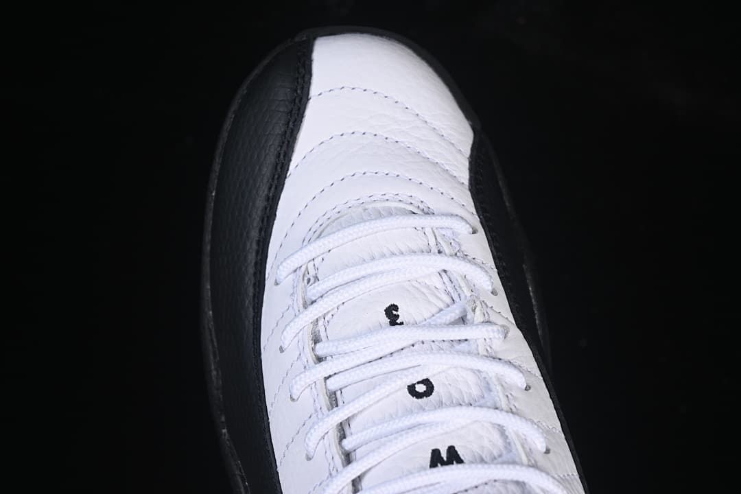 Top view of the sneaker showing white laces and stitched upper panels.