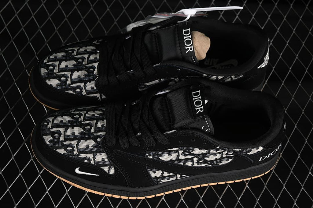 Top view of a pair of black patterned low-top sneakers with black laces and Dior lettering