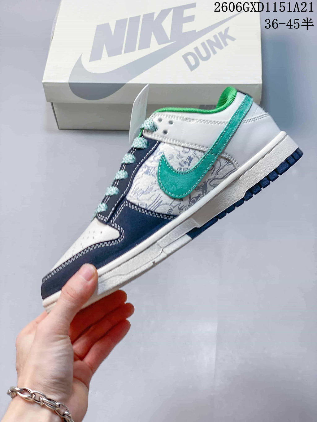 Side view showing the green side logo, patterned panel, and navy overlays