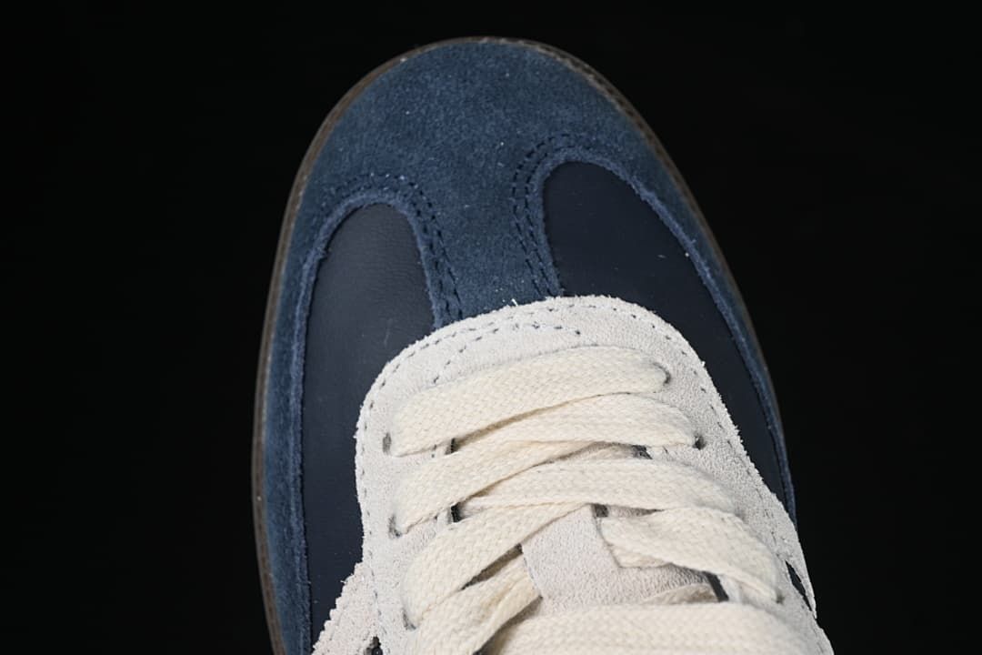 Top view of the navy toe, cream laces, and textured overlays