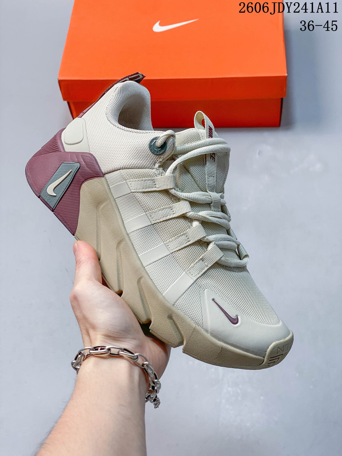 Cream-colored Nike Free Metcon 7 training shoe with muted mauve and gray accents.
