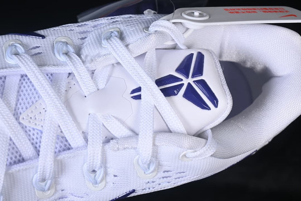 Close-up of the laces, tongue emblem and white upper