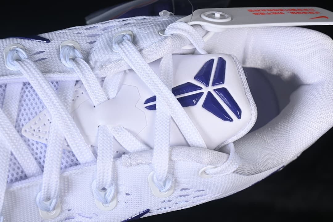 Close-up of the laces, tongue emblem and white upper