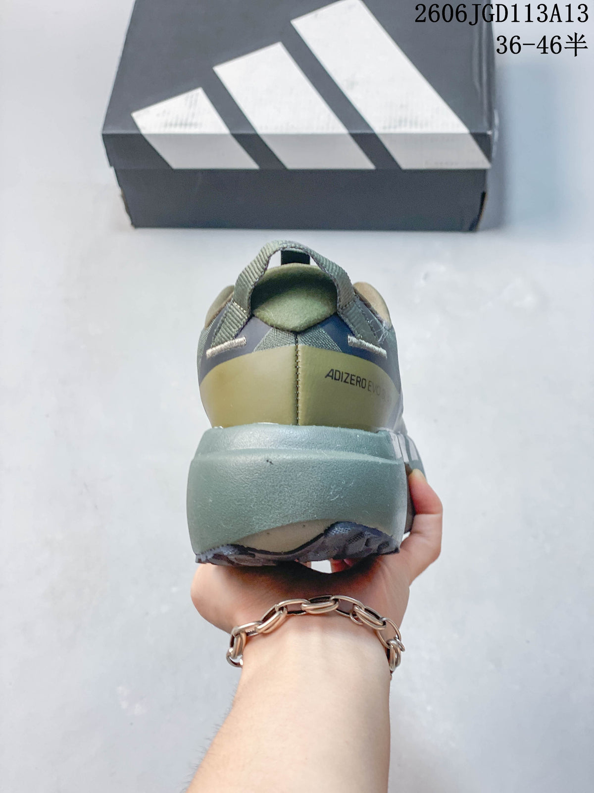 Rear view showing the heel and thick midsole of an olive running shoe