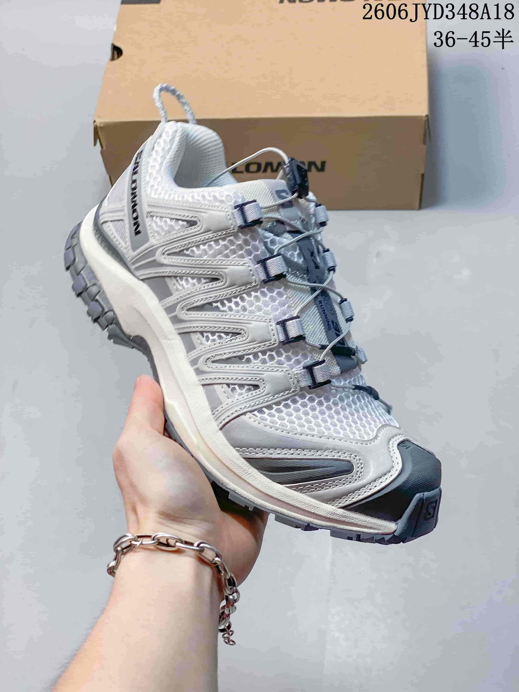 White and gray Salomon XT-3D trail shoes with quicklace-style closure.