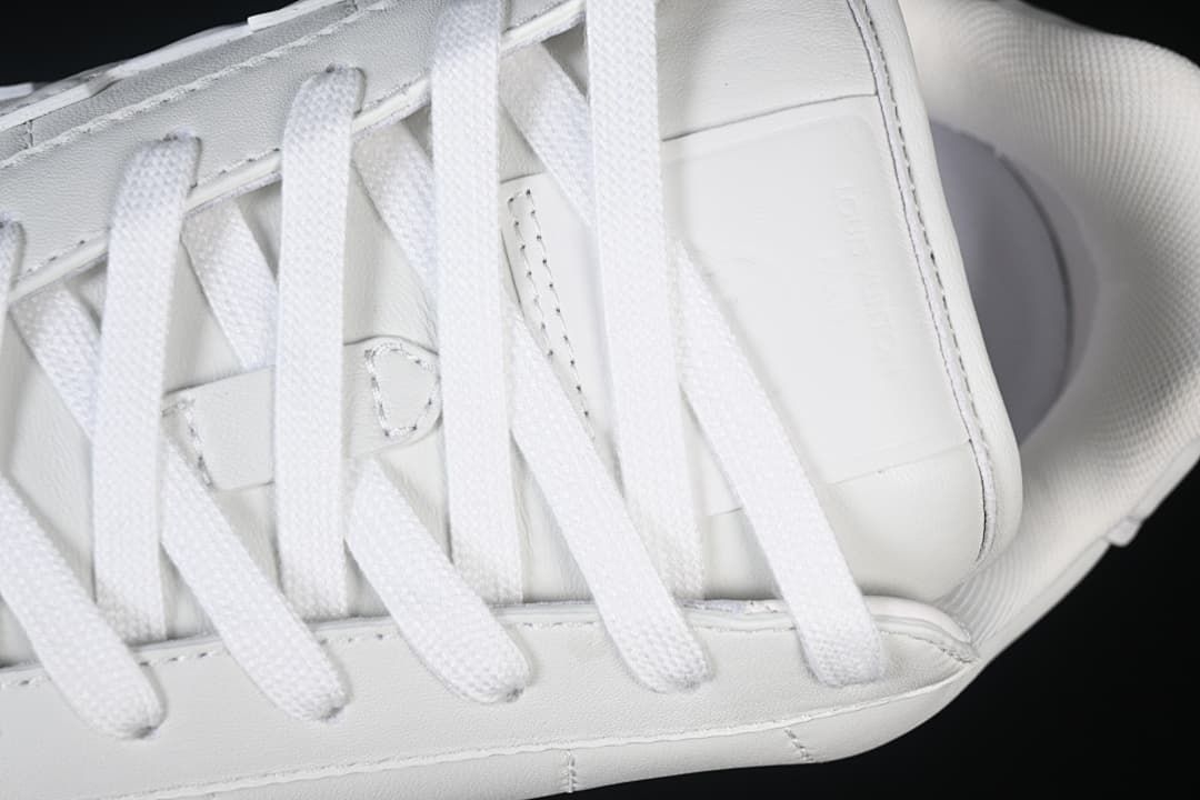 Close-up of white laces and upper panels