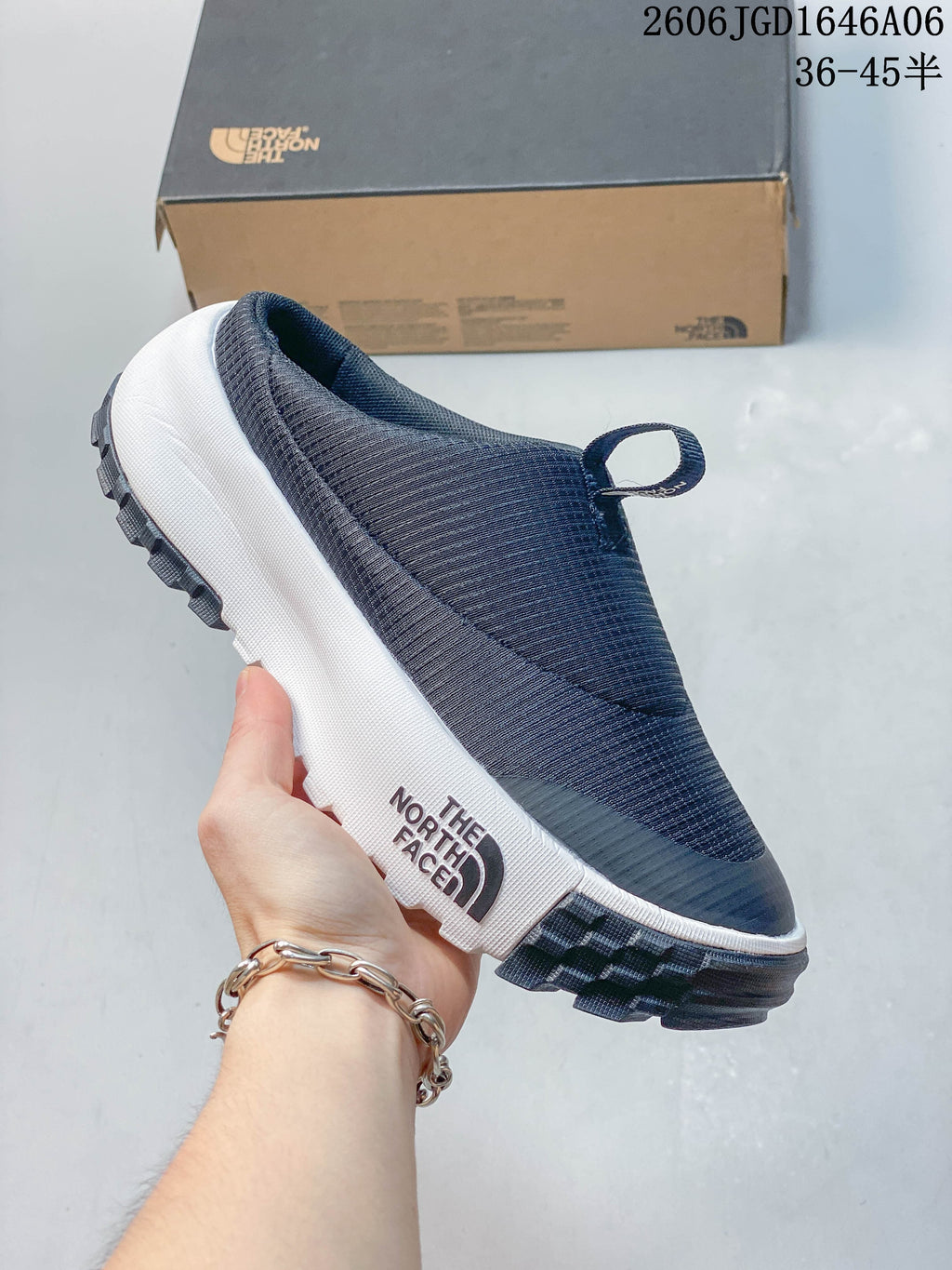 Side view of the navy mule with The North Face branding