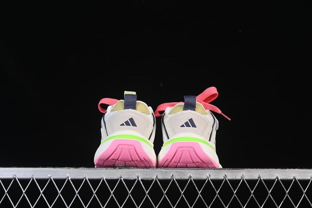 Rear view showing the pink outsole sections and lime green heel accents.