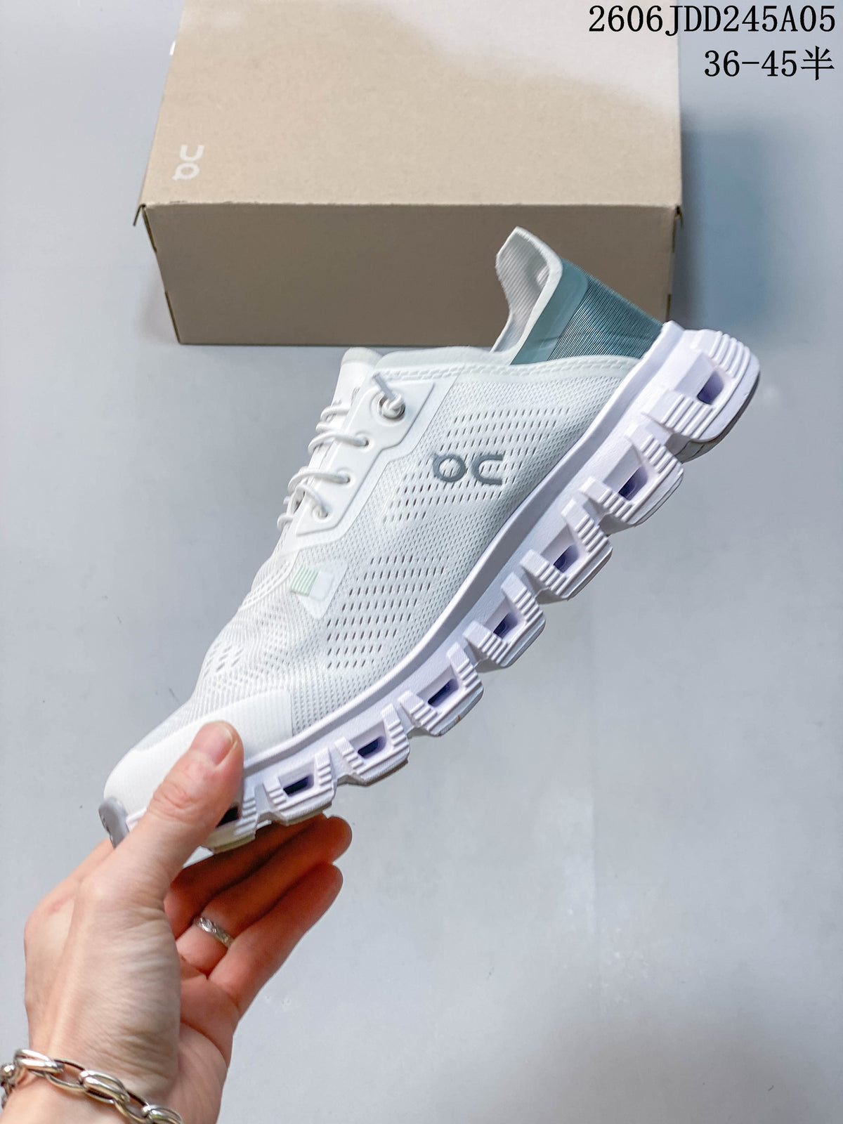 Side view of the white low-top shoe with pale blue-gray heel details.