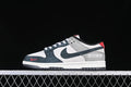 Side view of navy, gray, white, and red Nike SB Dunk Low sneakers
