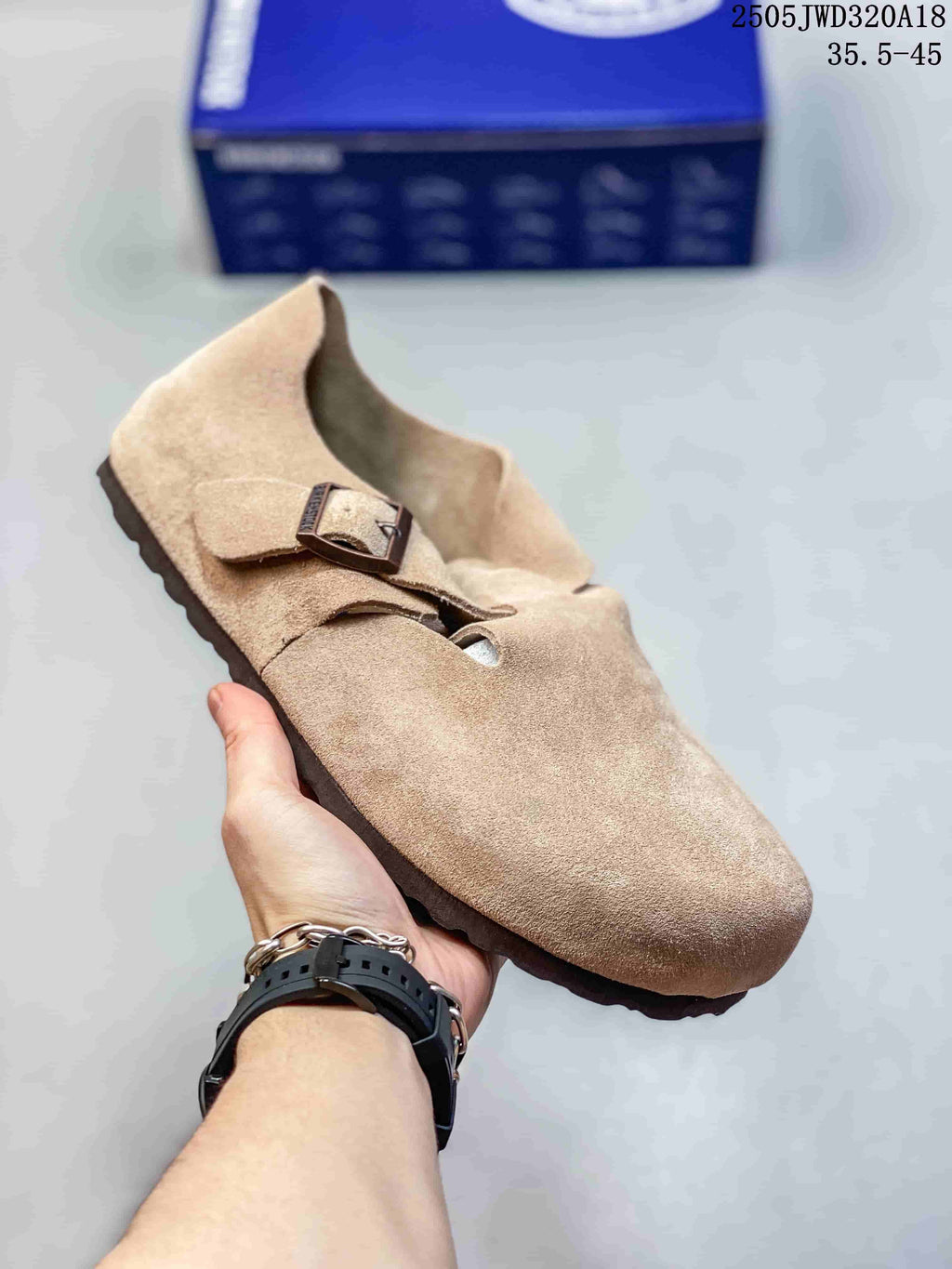 Beige closed-toe clog with two buckle straps; a box is visible in the background.