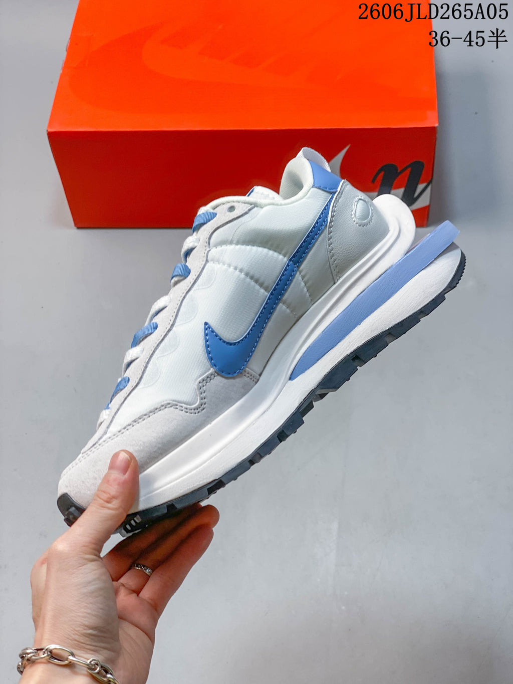 Side view showing the blue Swoosh, layered panels and sculpted midsole