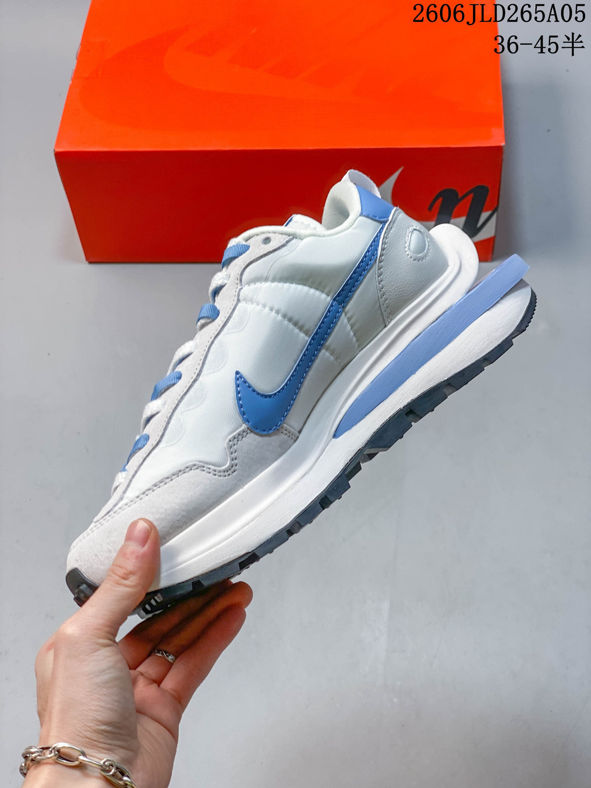 Side view showing the blue Swoosh, layered panels and sculpted midsole