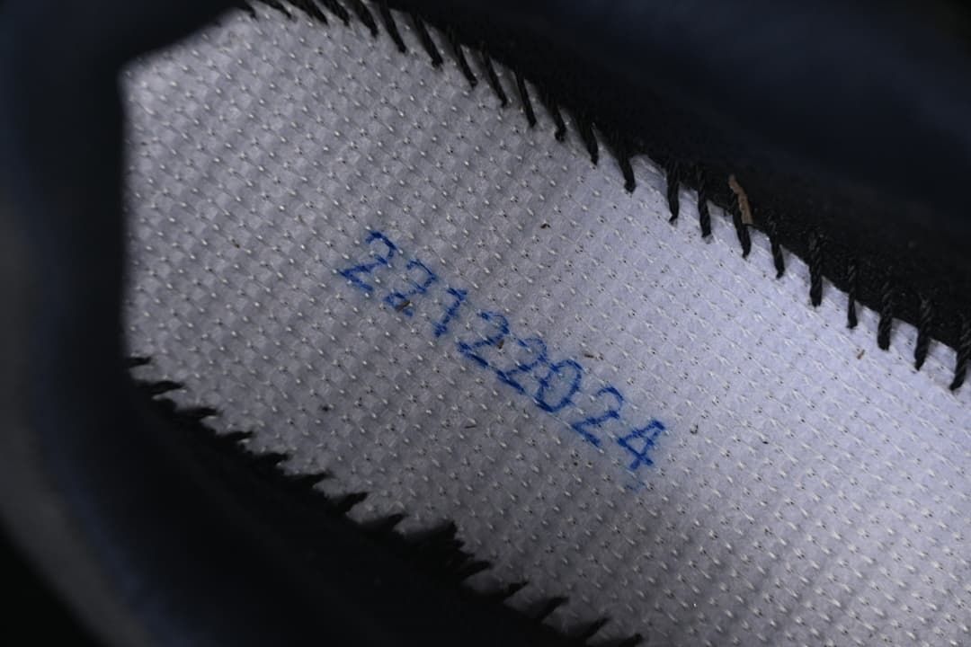Close-up of the inside stitching and handwritten markings on the shoe.