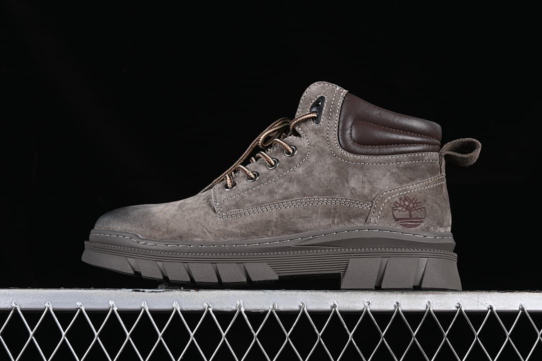 Side view of a brown Timberland-branded mid-top lace-up boot