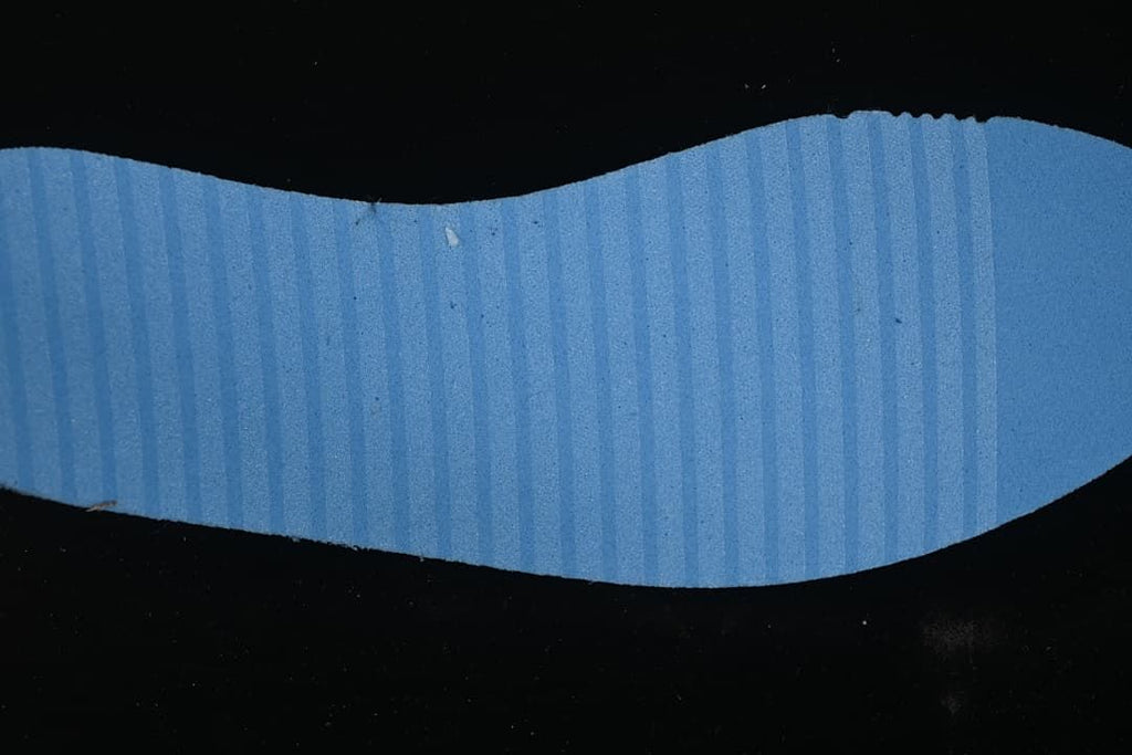 Blue shoe outsole shown against a dark background