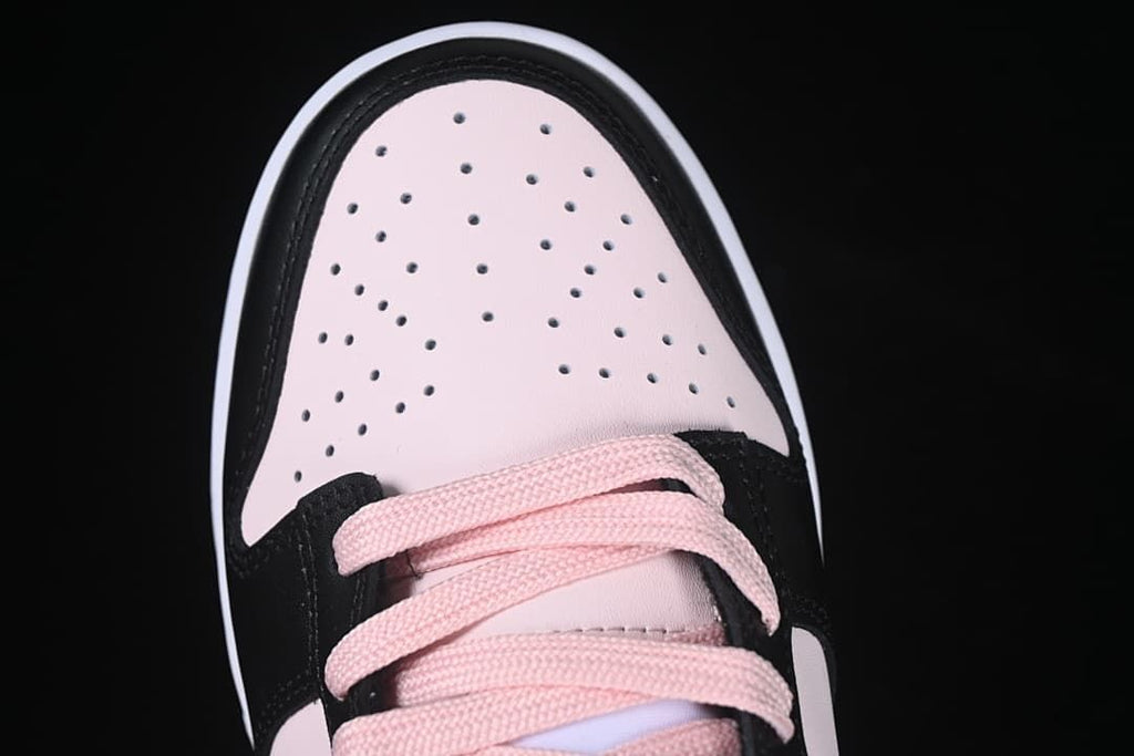 Top view of perforated pale pink toe panel and pink laces