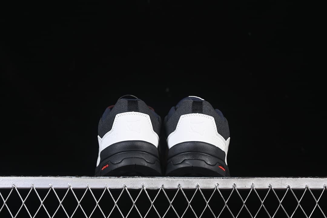 Rear view of both shoes showing the white heel panels and dark outsoles.